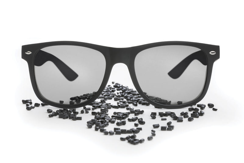 Load image into Gallery viewer, Pair of XD Collection GRS recycled PC plastic outdoor sunglasses with black frames and tinted lenses, designed for sun protection.
