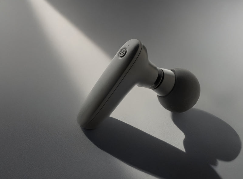 Load image into Gallery viewer, Reviv RCS recycled plastic massage gun from XD Collection, handheld device for muscle relaxation, in a home and living setting

