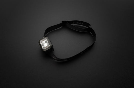 Gear X RCS plastic heavy duty head torch with adjustable strap and bright LED light for outdoor and work use.