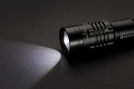Gear X USB rechargeable torch with bright LED light, compact tool for outdoor and emergency use, in black with ergonomic handle.