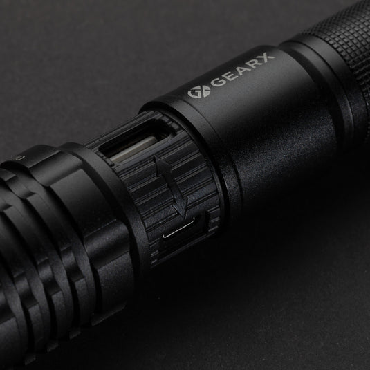 Gear X USB rechargeable torch with black handle, compact design, and adjustable focus for outdoor and emergency use.