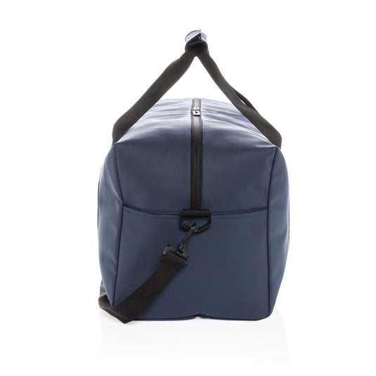 Smooth PU weekend duffle bag by XD Collection, showing its sleek design and sturdy handles in a natural travel setting.