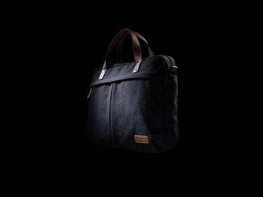 16 oz recycled canvas laptop bag from XD Collection, showing a stylish green eco-friendly bag with handles and zipper closure.