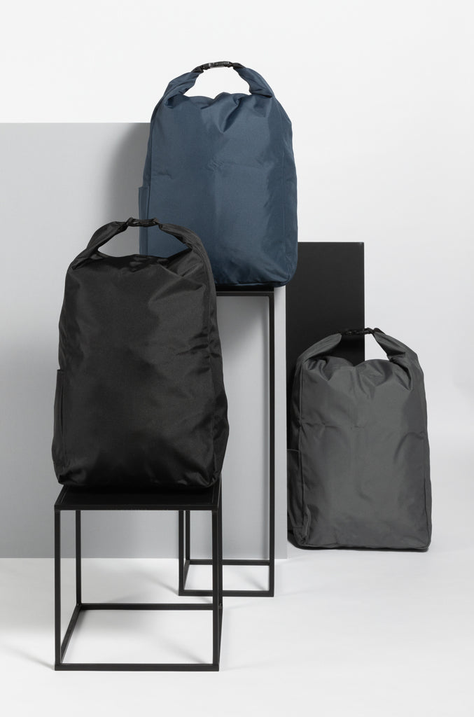 Load image into Gallery viewer, Lightweight Impact AWARE™ RPET rolltop backpack from XD Collection, showing its durable design and spacious main compartment.
