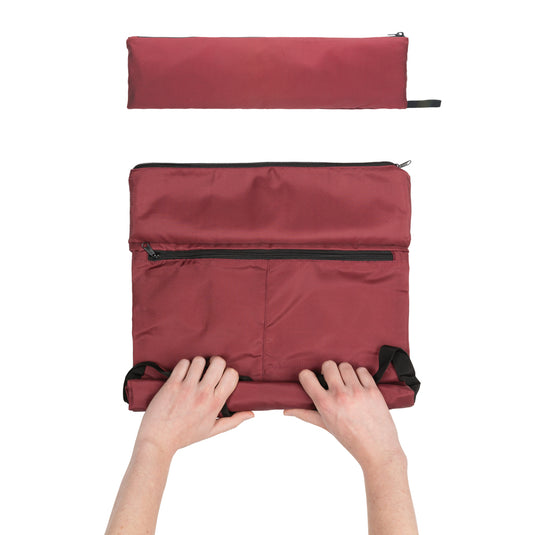 Lightweight foldable Dillon AWARE™ RPET backpack by XD Collection, shown folded and partially unfolded, in vibrant colors.