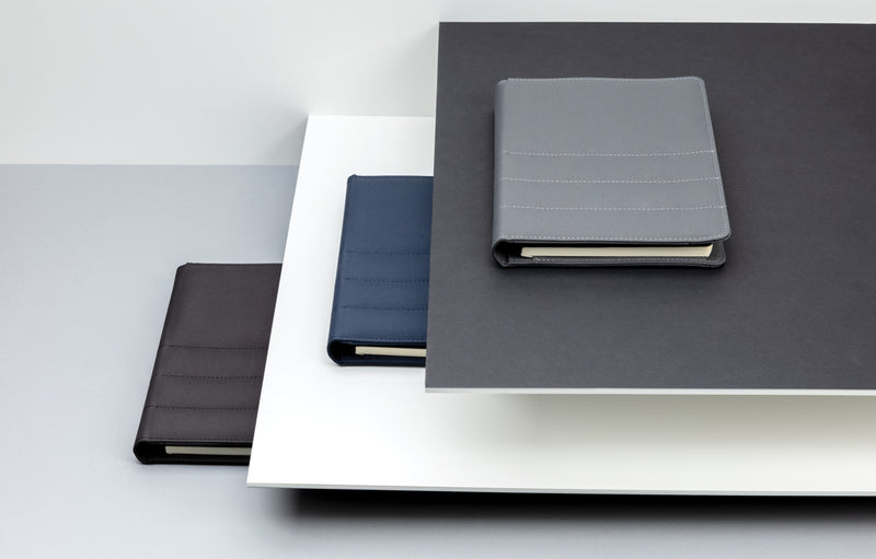 Load image into Gallery viewer, Impact AWARE™ RPET A5 notebook by XD Xclusive, showing green recycled material cover with spiral binding and lined pages.
