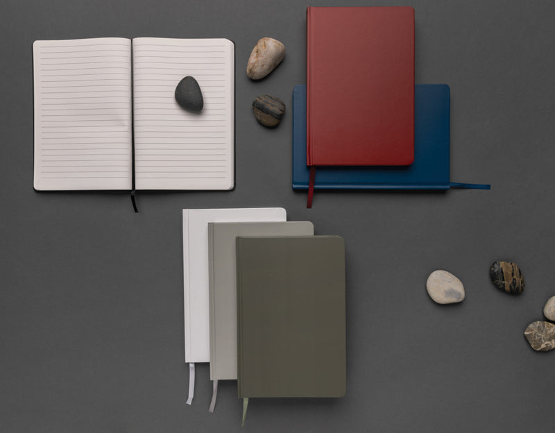 Load image into Gallery viewer, A5 Impact stone paper hardcover notebook by XD Collection, featuring a sleek black cover and spiral binding.
