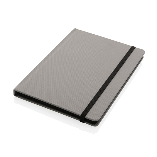 A green GRS certified RPET A5 notebook from XD Collection with a textured cover and spiral binding, suitable for writing and note-taking.
