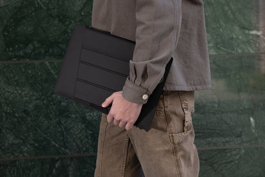 XD Design 14-inch mobile office sleeve with padded interior and sleek black design, ideal for protecting laptops during travel.