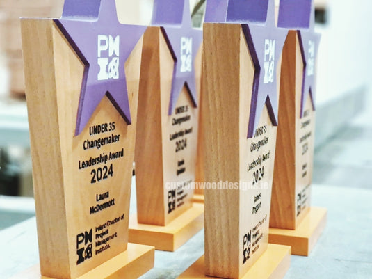 Custom Wood Designs purple wooden awards, custom-made recognition trophies with elegant finish and engraved details.
