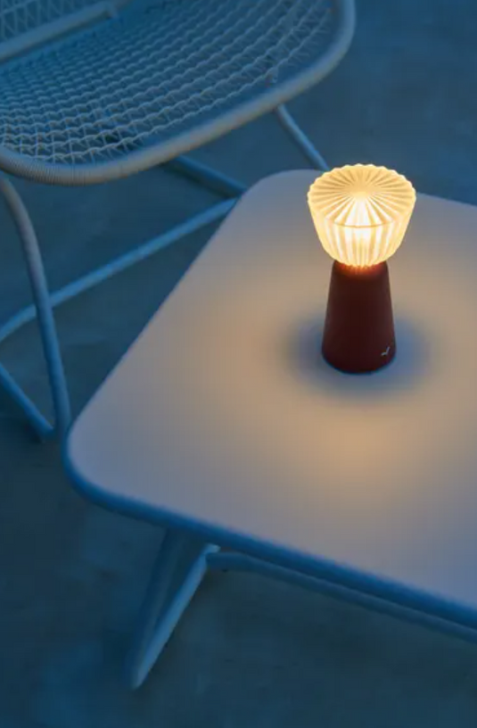 Set of 6 Fermob Swing lamps with rechargeable design and charging tray, outdoor lighting for patio or garden ambiance.