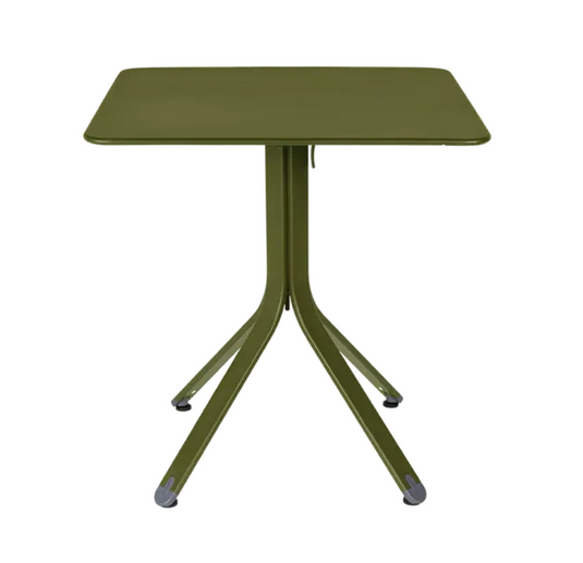 Fermob Rest'O folding outdoor table in metal, 71x71cm, shown in a natural setting with a green pesto finish.