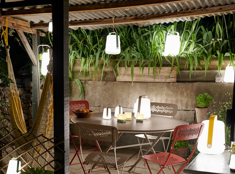 Load image into Gallery viewer, Fermob Caractère foldable metal table with 128 cm diameter, eight-seater, shown folded and open for outdoor dining.
