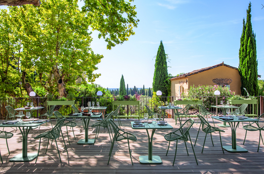 Fermob Sixties stackable knitted outdoor chair with a modern design and colorful woven seat, suitable for garden or patio.