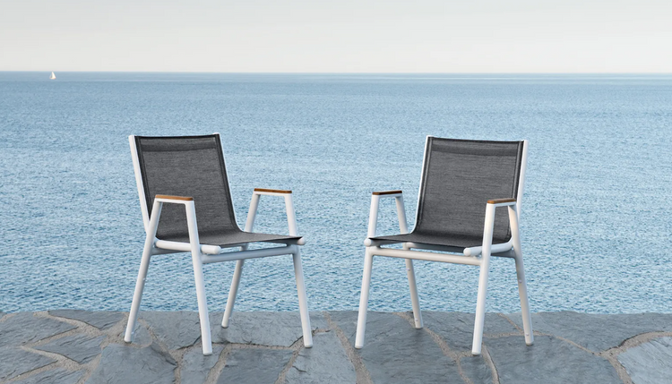 Fermob Pilotis V Batyline teak armchair with woven Batyline fabric and teak wood frame, suitable for outdoor restaurant or hotel use.