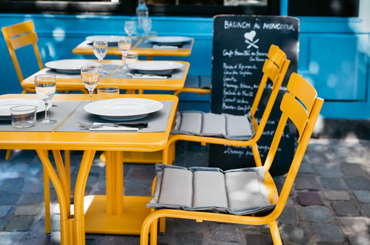 Fermob BASICS placemat measuring 45 x 35 cm with a woven design, ideal for dining tables, in natural tones.