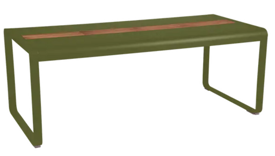 Fermob Bellevie outdoor dining table with wood and metal design, 196x90cm, eight-seater with built-in storage, in a garden setting.