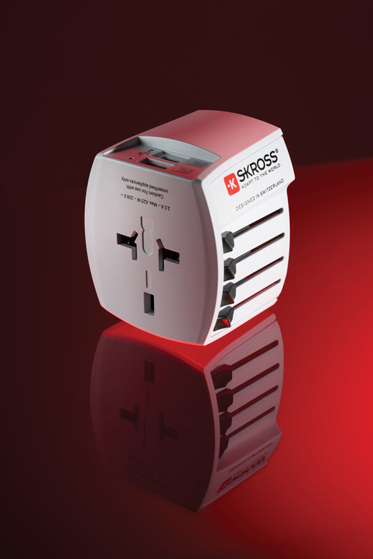 Skross SKROSS World Travel Adapter MUV with 2-pole plug, USB-A and USB-C ports for phone and tablet charging.