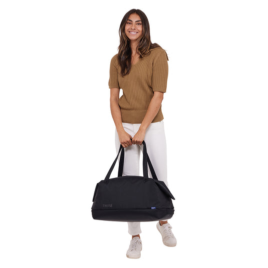 Thule Subterra 2 Duffel 35L bag in black with shoulder strap and zippered compartments, designed for travel and storage.