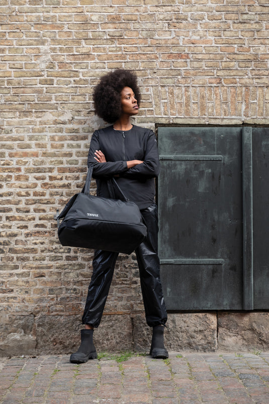 Thule Subterra 2 Duffel bag in black, 35L capacity, showing the durable fabric and sturdy handles for travel and storage.