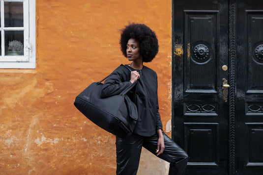 Thule Subterra 2 Duffel 35L in black, showing its durable fabric and sturdy handles for travel and storage use.