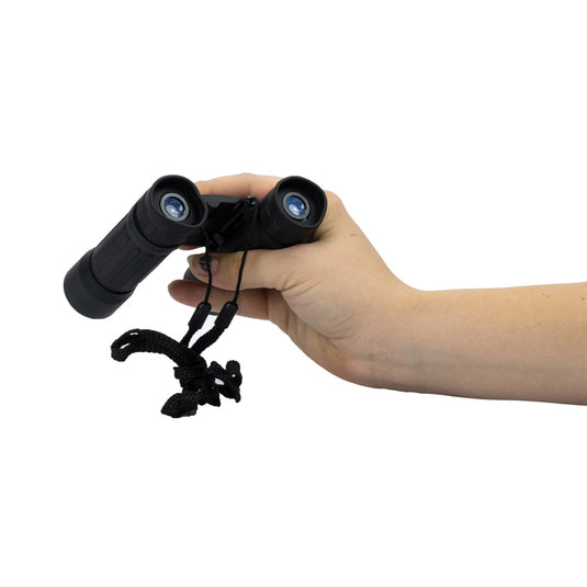 Homeys Xtrail B2 BAK7 outdoor binoculars with 10x25 magnification and compact design, shown in a natural outdoor setting.