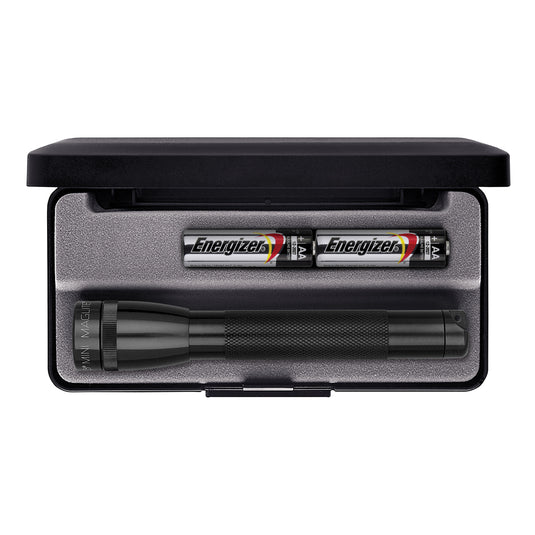 MAGLITE Mini AA LED torch held in hand, compact tools and flashlight with bright LED light, black body, and textured grip.