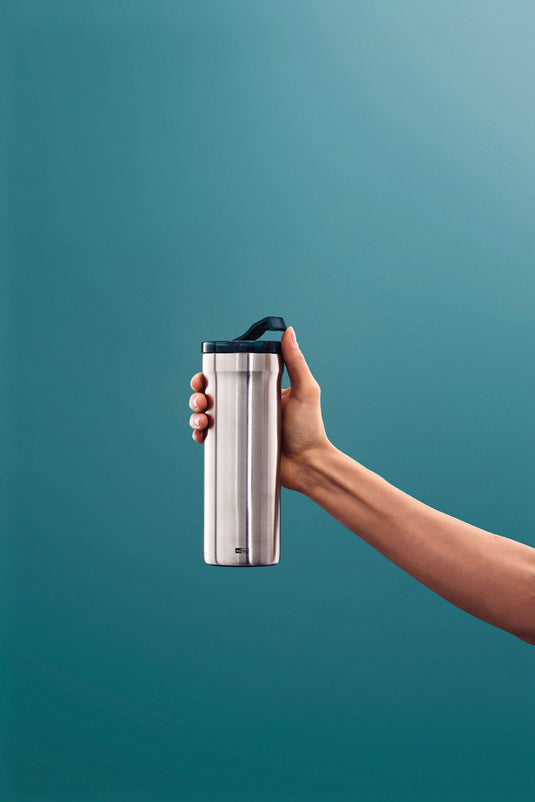 AdHoc Thermal Mug Pulse in stainless steel with black lid, designed for hot beverages, showcasing its sleek, modern design.