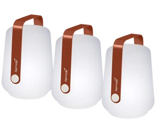 Set of three Fermob Balad mini outdoor lamps in Red Ochre, 12 cm tall, featuring small spherical design for outdoor lighting.
