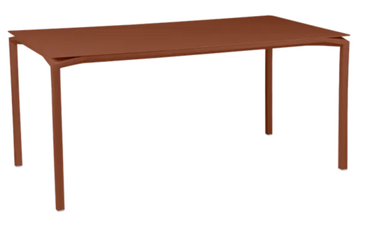 Red Ochre Fermob CALVI rectangular kitchen table, 160 x 80 cm, six-seater with sturdy metal design in an outdoor setting.