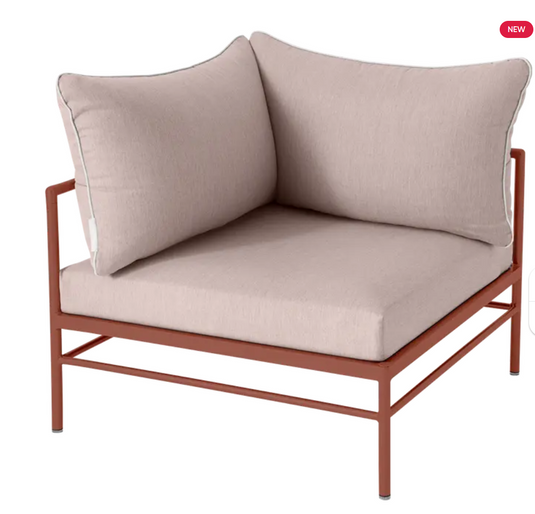 Red ochre Fermob Rivage corner outdoor armchair with metal frame, showcasing its stylish and comfortable design.