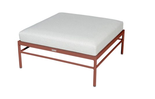 Red ochre Fermob Rivage outdoor ottoman with aluminum frame, stylish metal lounge footstool for outdoor furniture.