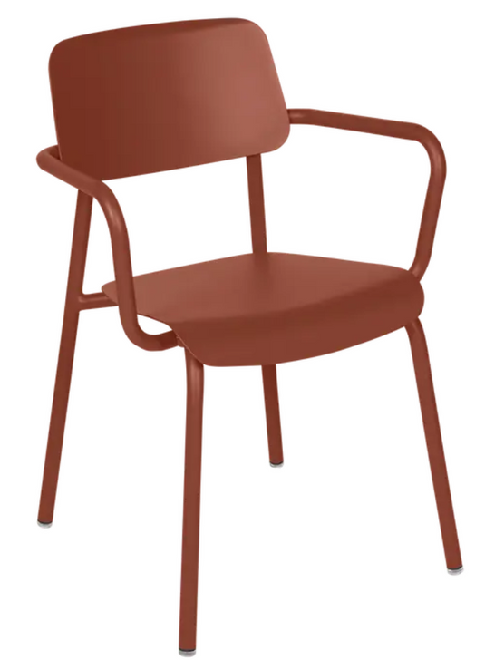 Red ochre Fermob Studie armchair, stackable indoor dining chair with modern design, suitable for home and office use.