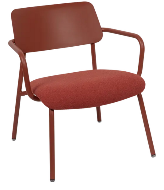 Red ochre Fermob Studie fabric lounge armchair with metal frame, designed for office or lounge settings.