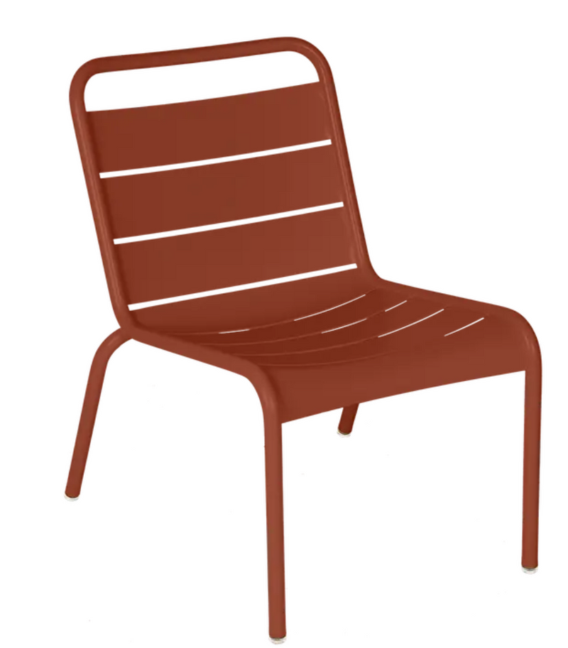 Load image into Gallery viewer, Red ochre Fermob Luxembourg lounge chair with a metal frame, designed for outdoor use and comfortable seating.
