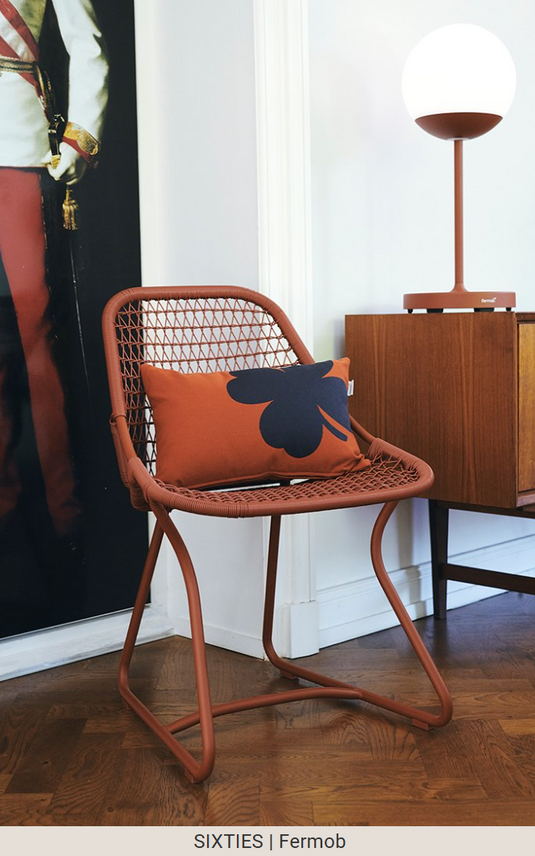 Red ochre Fermob Sixties outdoor stackable chair for restaurant and hospitality use, showcasing stylish metal seating for outdoor spaces.