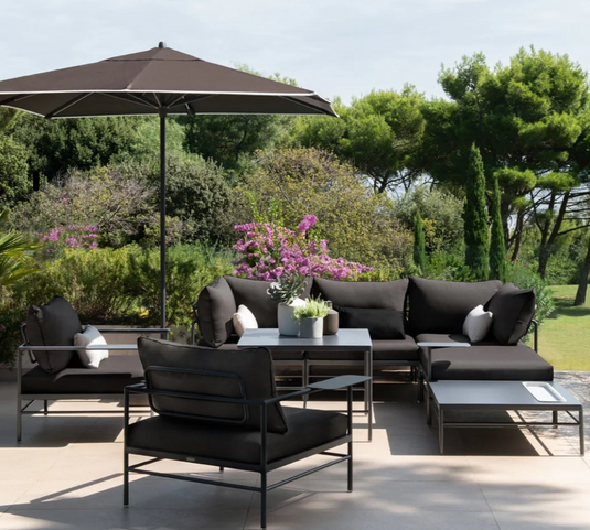 Fermob Rivage Ottoman outdoor metal furniture with fabric cover, featuring sleek design and silver finish.
