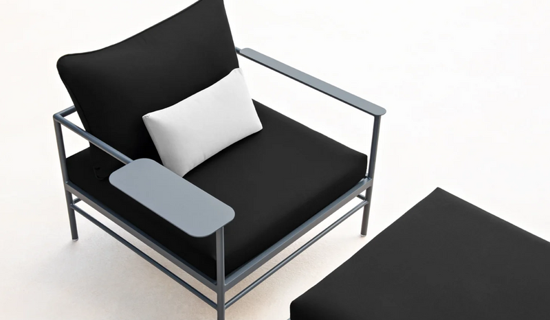 Load image into Gallery viewer, Fermob Rivage Ottoman outdoor furniture with metal frame and fabric cover, shown on a shelf in an outdoor setting
