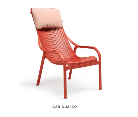 Pink Sunbrella Nardi Net Chair Cushion on a lounge chair, showcasing comfortable outdoor seating accessory.