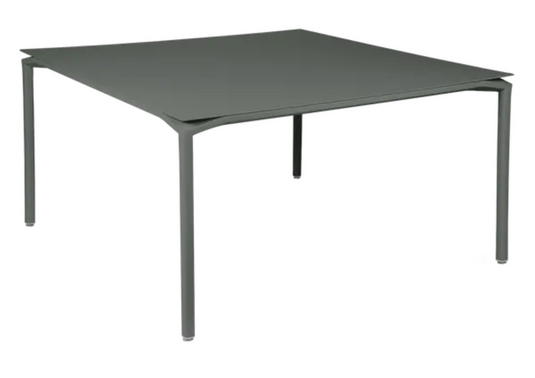 Fermob CALVI square dining table 140x140 cm with eight seats, made of metal, shown in a modern outdoor setting.