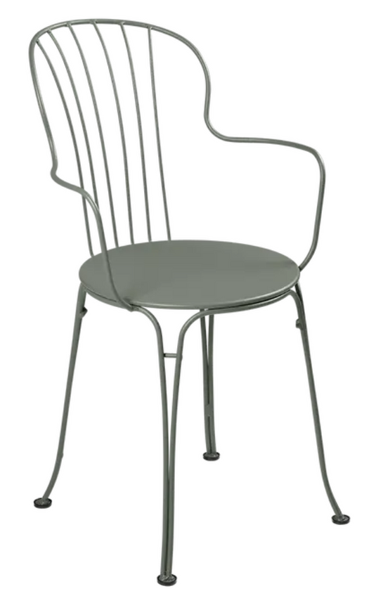 Fermob OPÉRA+ outdoor metal armchair with a stylish design, featuring a curved backrest and armrests in a vibrant finish.