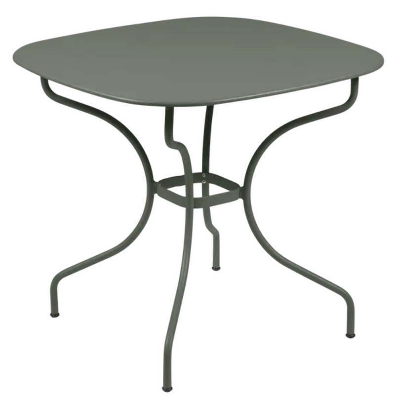 Load image into Gallery viewer, Fermob OPÉRA+ Carronde outdoor metal table, 82x82 cm, shown in a garden setting with a modern design and smooth surface.
