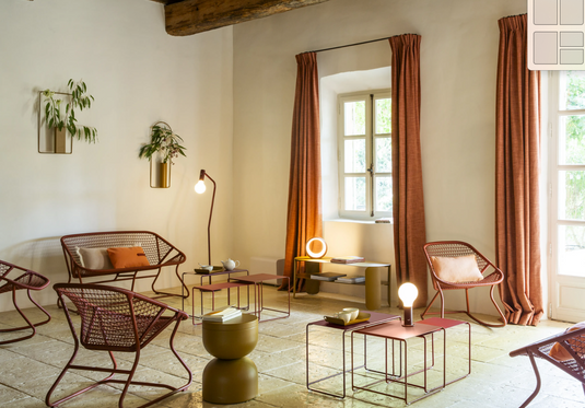 Fermob Sixties outdoor sofa with colorful cushions on a patio, modern garden furniture design