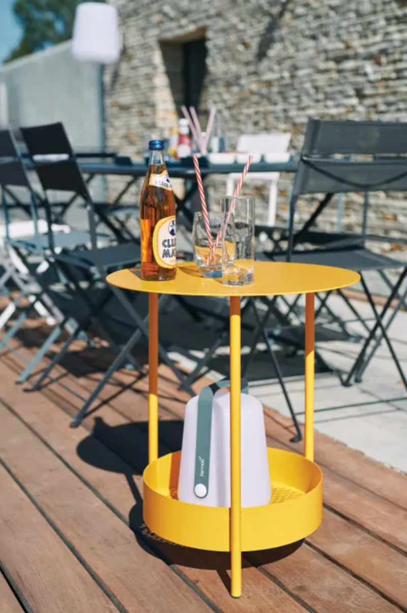 Load image into Gallery viewer, Fermob Salsa pedestal side table with a round top and pedestal base, suitable for outdoor use in a modern patio setting.
