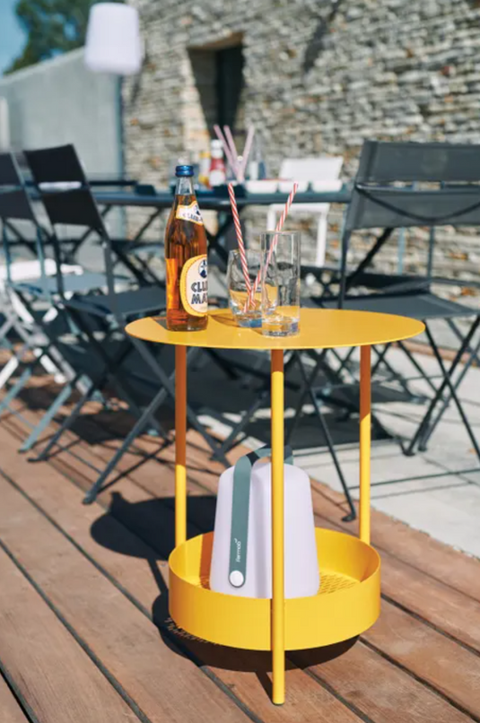 Fermob Salsa pedestal side table with a round top and pedestal base, suitable for outdoor use in a modern patio setting.