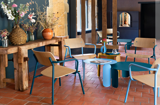 Stacked Fermob Studie Oak Lounge Armchairs with metal frames, designed for modern office and lounge spaces.