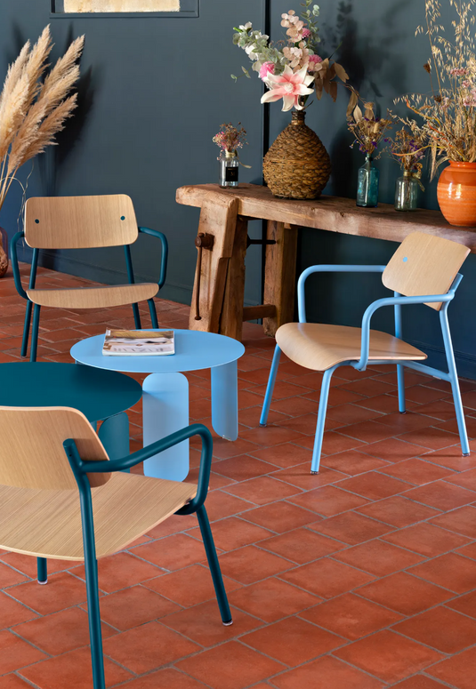 Stacked Fermob Studie Oak Lounge Armchairs with metal frames, showcasing modern, stackable office lounge seating.