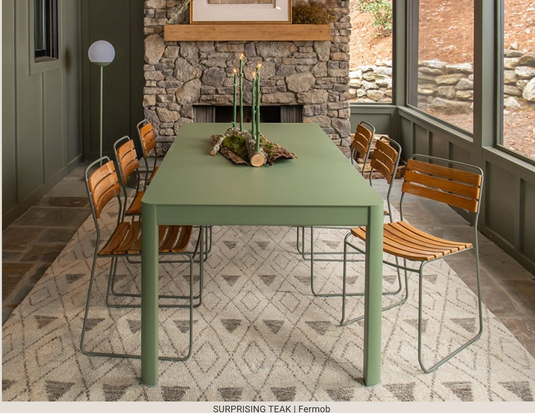 Fermob outdoor metal chair featuring a surprising teak seat, perfect for garden or patio furniture.