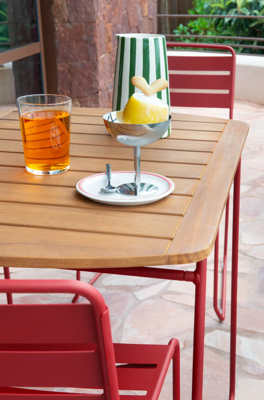 Fermob Surprising outdoor chair with colorful, modern design and curved metal frame, perfect for patio or garden seating.