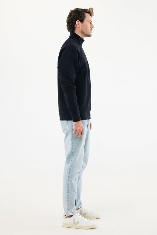 Iqoniq Elgon recycled cotton quarter zip sweater, textile product with a close-up of the fabric and quarter-zip neckline.